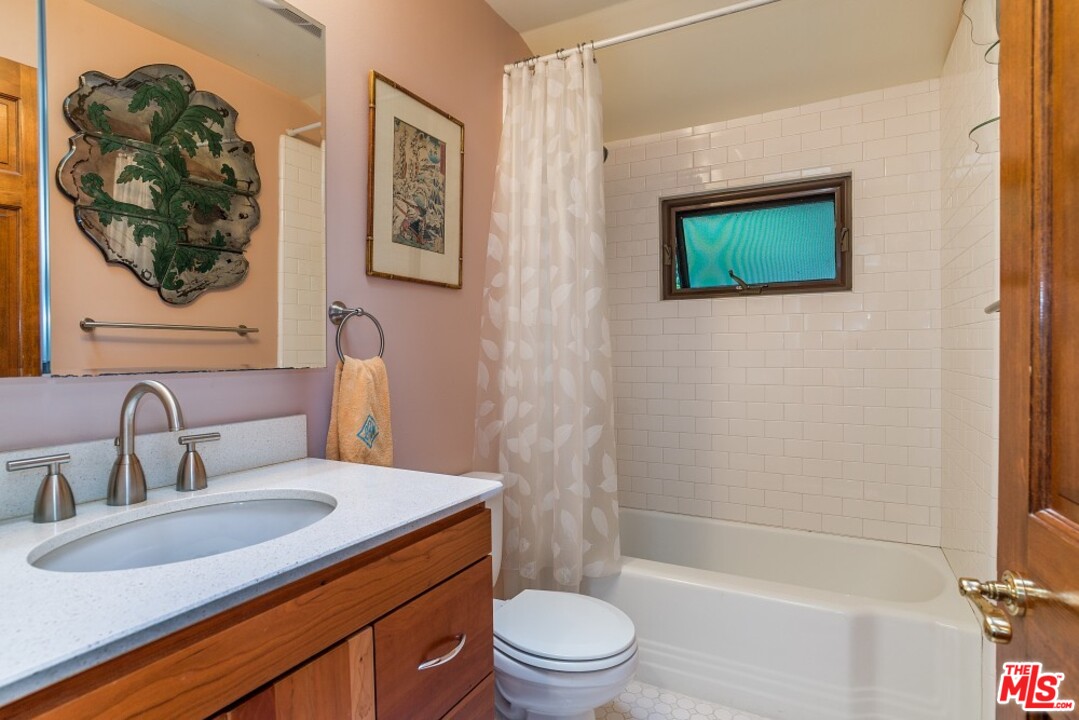 3266 Mandeville Canyon Road Los Angeles, CA 90049 - Photo 22 of 37 a bathroom with a sink toilet and shower