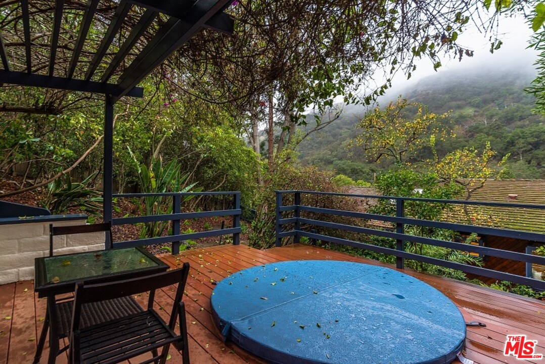 3266 Mandeville Canyon Road Los Angeles, CA 90049 - Photo 29 of 37 a view of a chairs and table in the outdoor