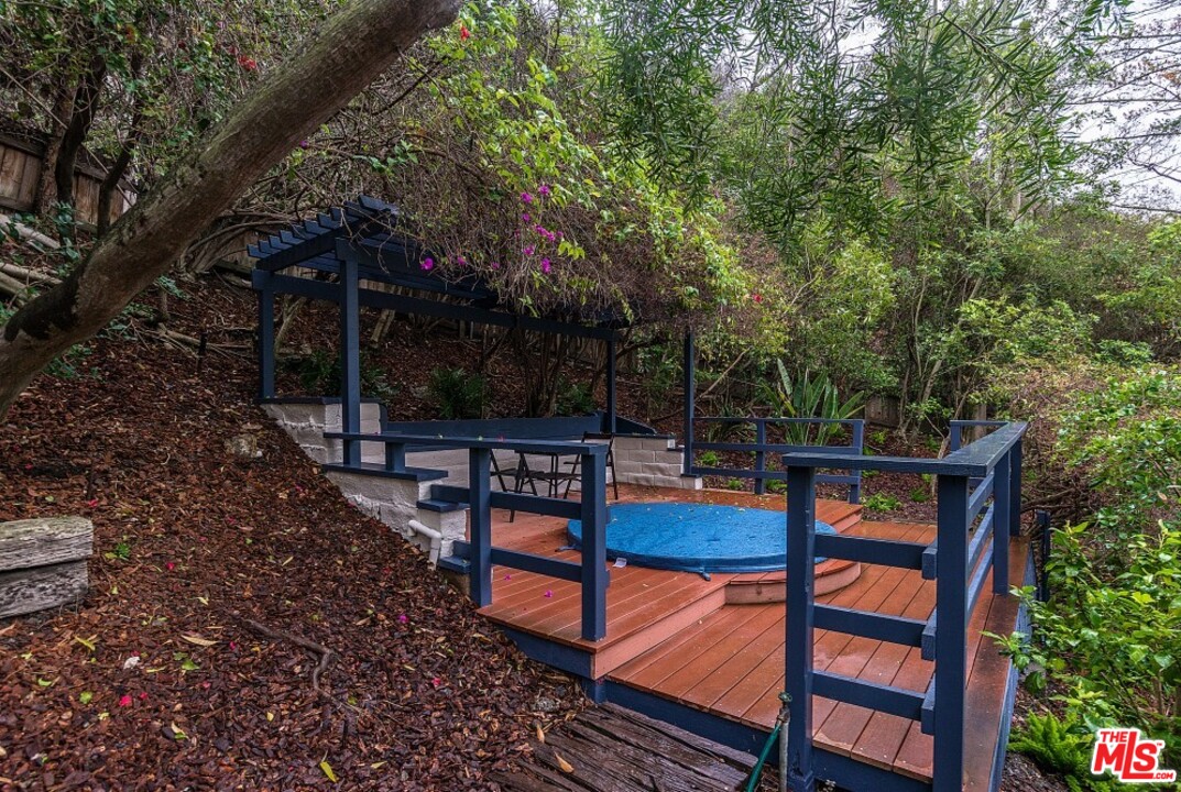 3266 Mandeville Canyon Road Los Angeles, CA 90049 - Photo 30 of 37 a view of a chairs and tables in the back yard
