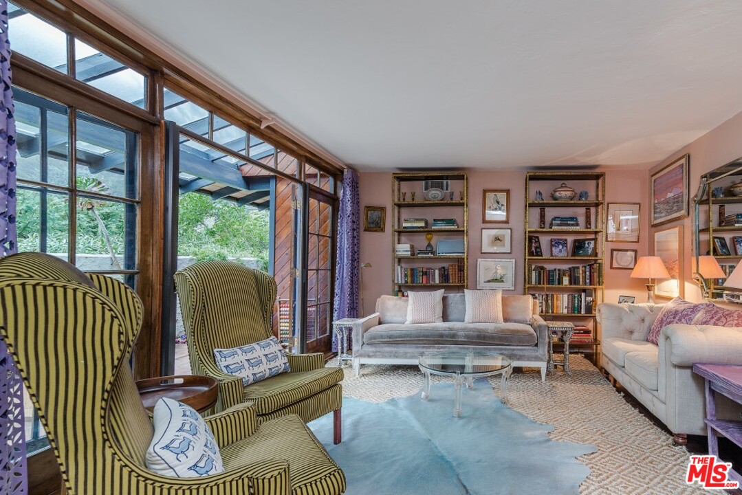 3266 Mandeville Canyon Road Los Angeles, CA 90049 - Photo 4 of 37 a living room with furniture a rug and a large window