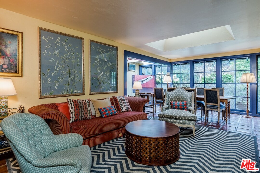 3266 Mandeville Canyon Road Los Angeles, CA 90049 - Photo 6 of 37 a living room with furniture a table and a large window