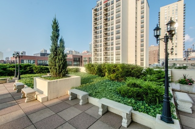 230 West Division Street, Unit 1005 Chicago, IL 60610 - Photo 14 of 15 a view of a patio with a table and chairs and potted plants
