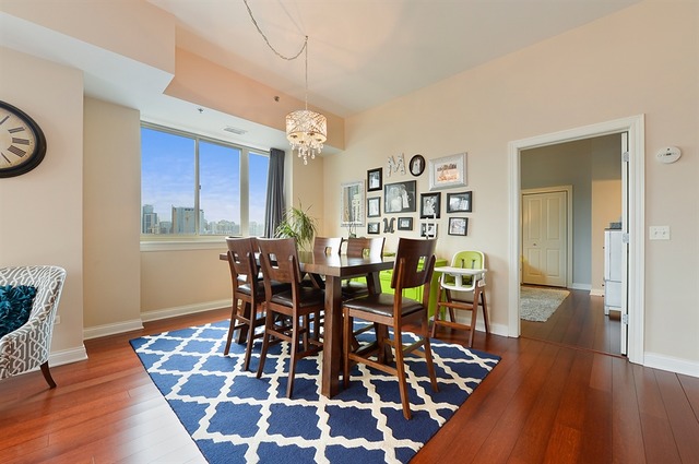 230 West Division Street, Unit 1005 Chicago, IL 60610 - Photo 5 of 15 a view of a dining room with furniture and wooden floor
