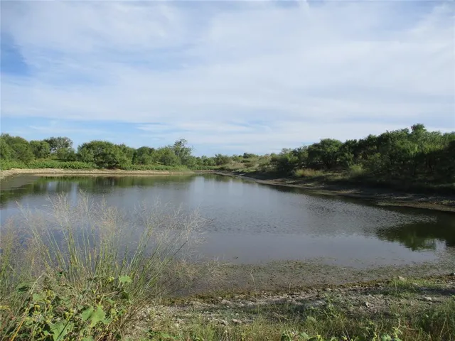 a view of a lake with houses in the back