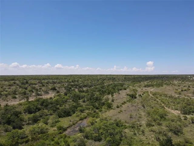 an aerial view of residential houses with city view