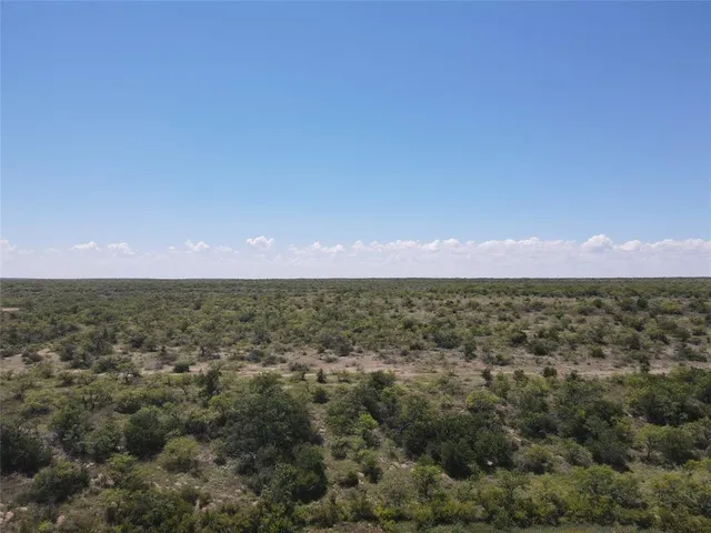 an aerial view of residential houses with city view