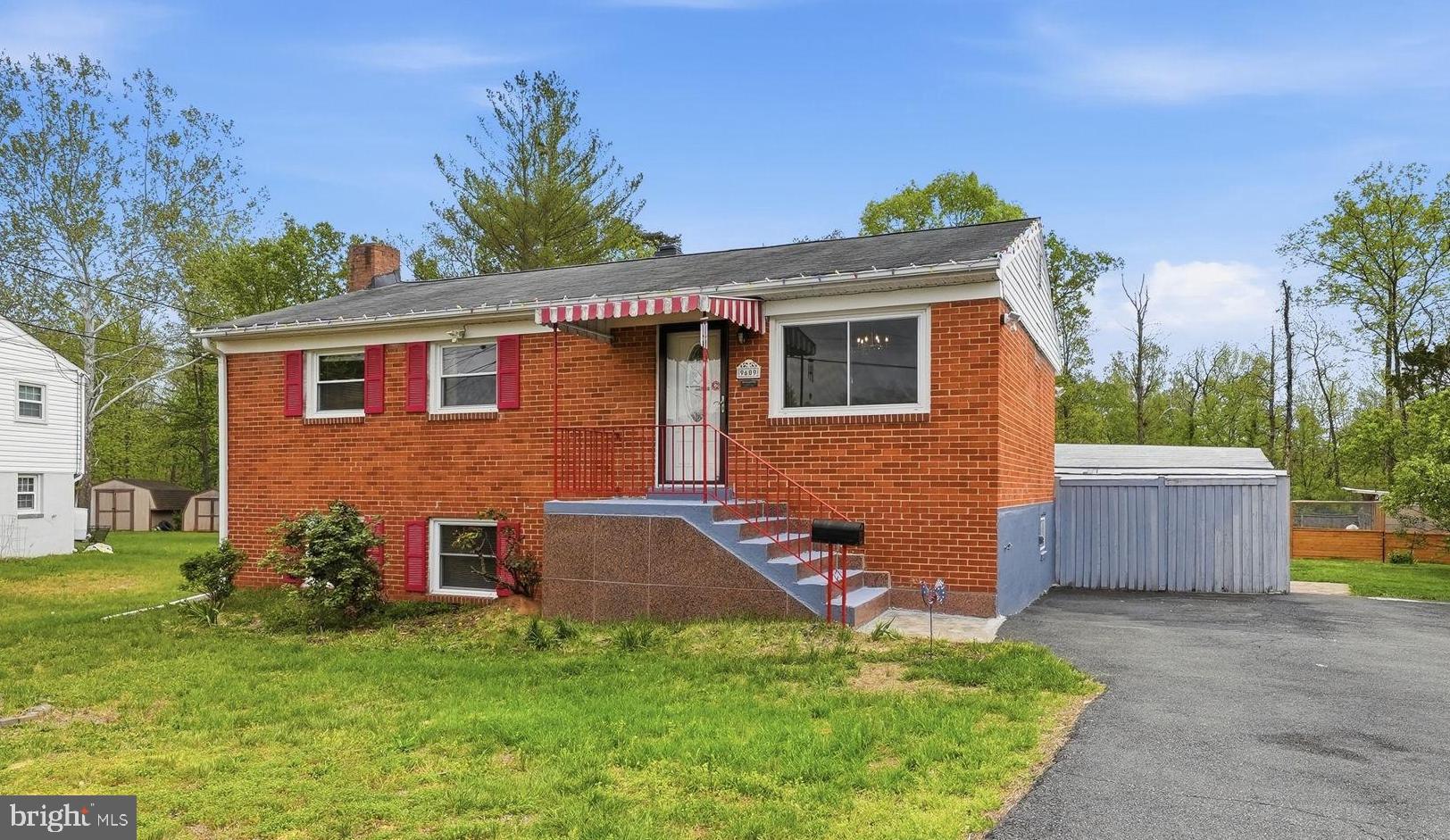 9609 Norfolk Street Manassas, VA 20109 - Photo 1 of 37 a front view of house with yard and trees in the background