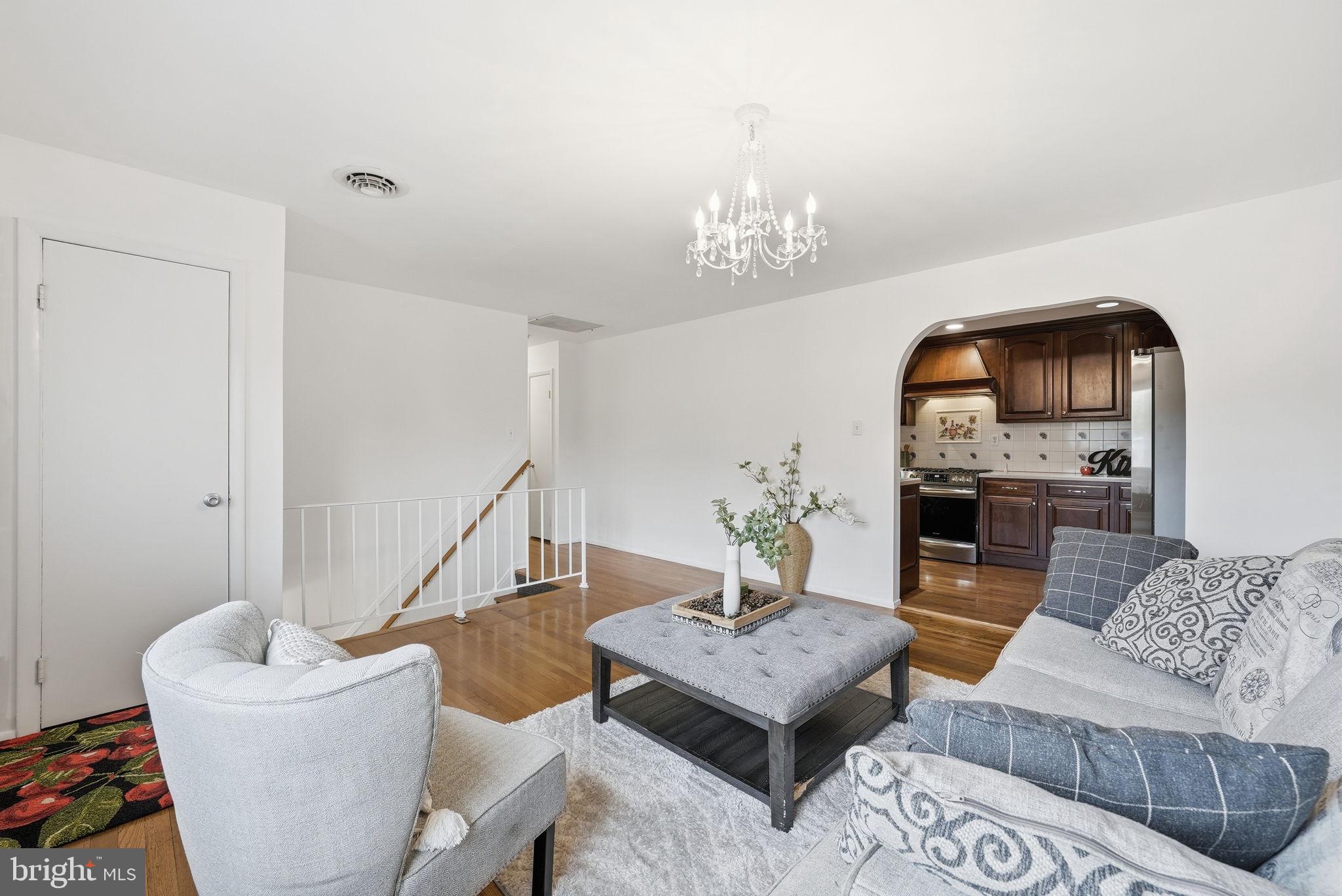 9609 Norfolk Street Manassas, VA 20109 - Photo 19 of 37 a living room with furniture and a chandelier