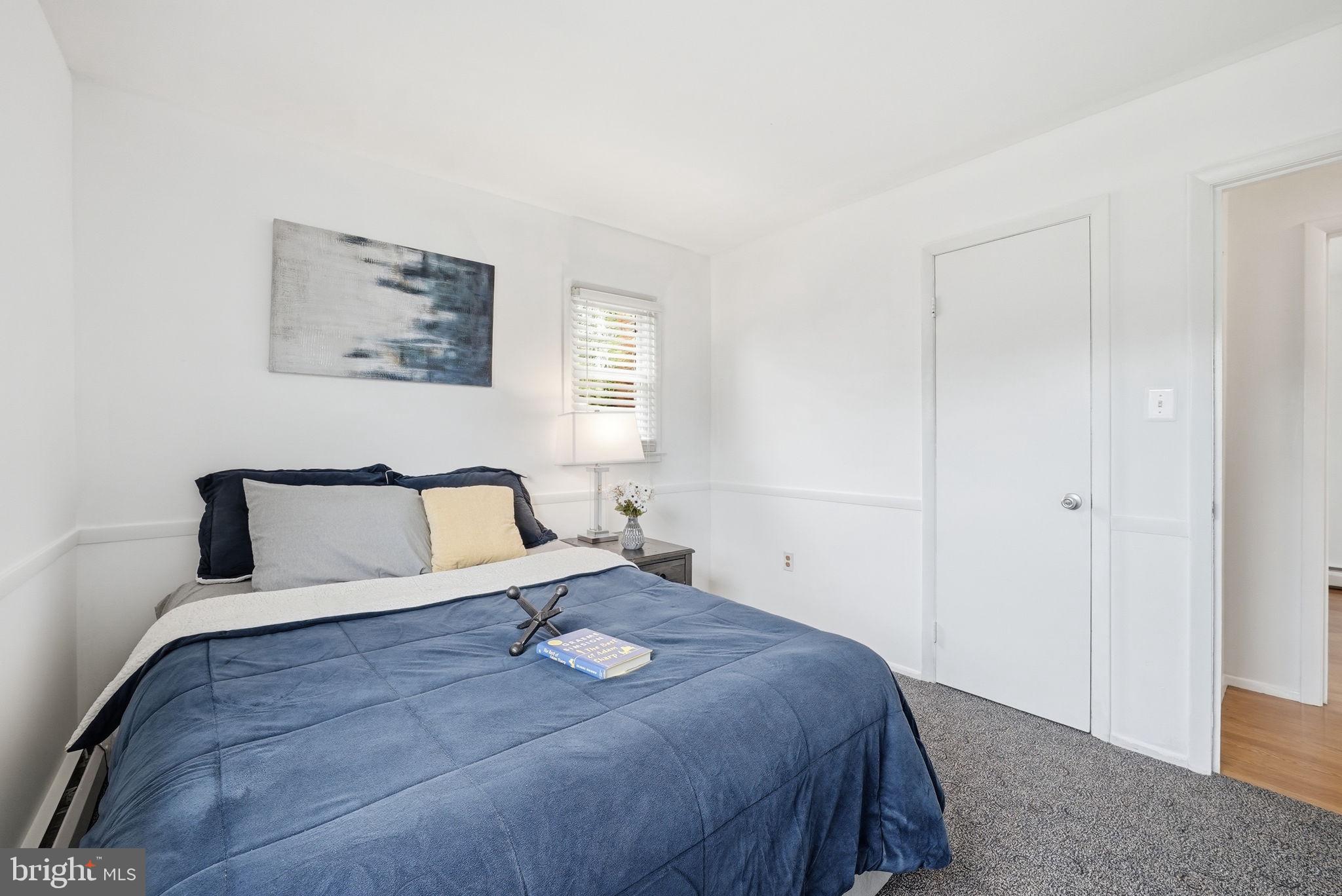 9609 Norfolk Street Manassas, VA 20109 - Photo 26 of 37 a bedroom with a large bed and a window