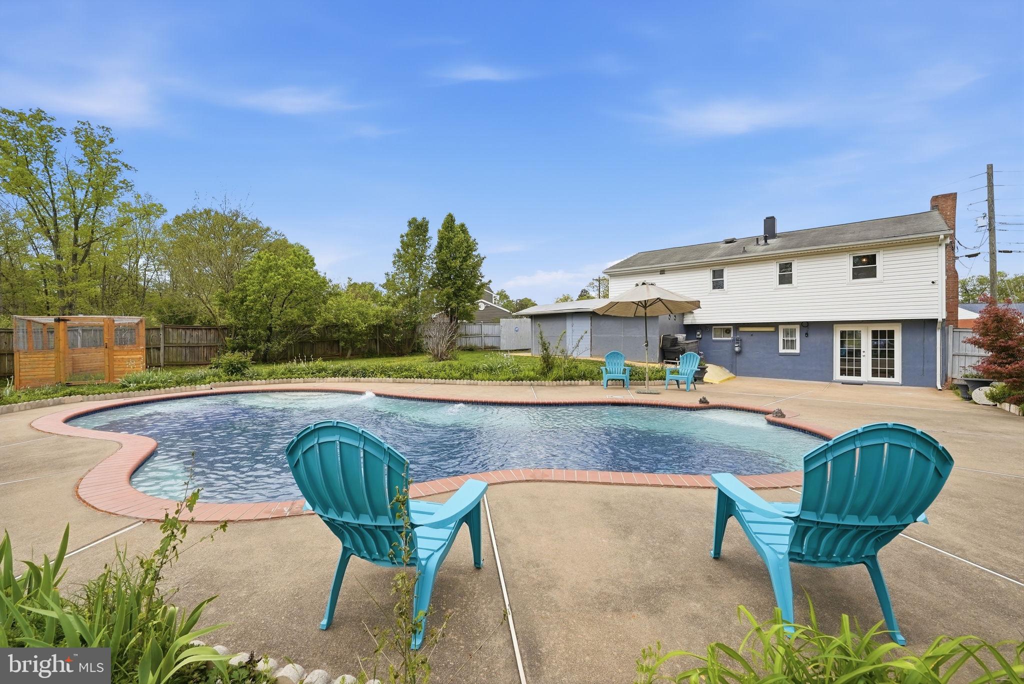 9609 Norfolk Street Manassas, VA 20109 - Photo 30 of 37 a view of a swimming pool with a lounge chair