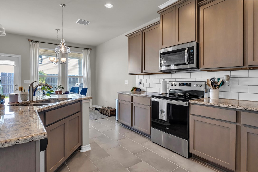 1033 Ocean Breeze Portland, TX 78374 - Photo 27 of 38 a kitchen with a sink stove and microwave
