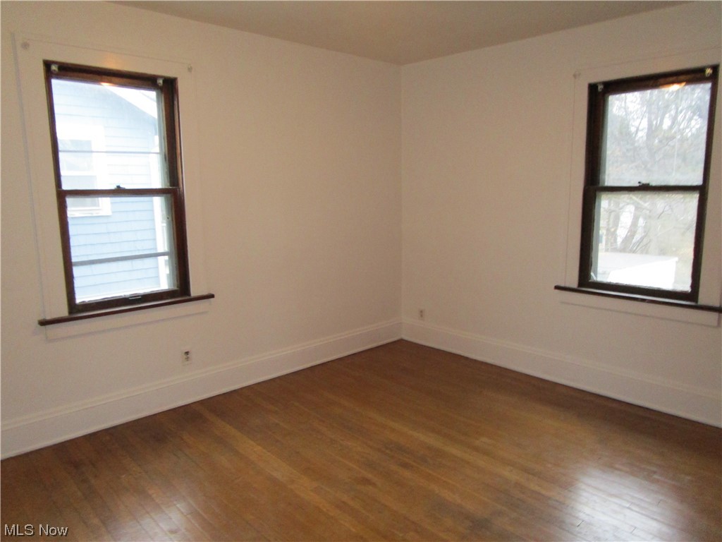 3796 Lowell Road Cleveland Heights, OH 44121 - Photo 6 of 11 Empty room featuring dark hardwood / wood-style floors and a healthy amount of sunlight