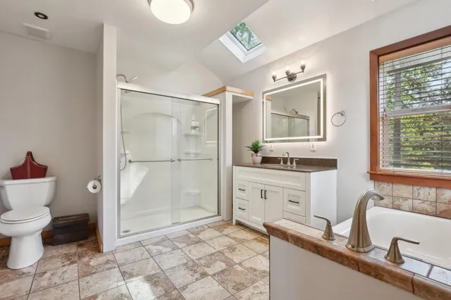 a bathroom with a sink toilet a mirror and shower