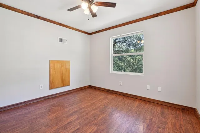 wooden floor in an empty room with a window