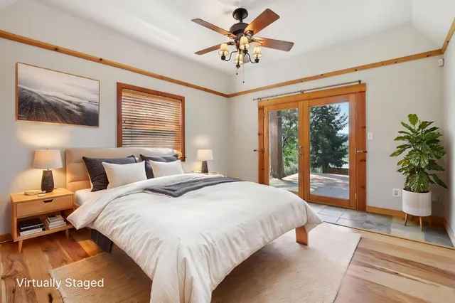 a spacious bedroom with a large bed and a chandelier