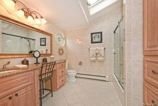 a spacious bedroom with a bed and a chandelier