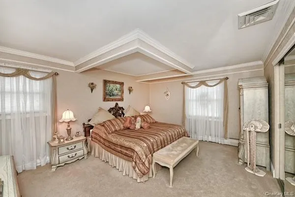 a bedroom with a bed and ceiling fan