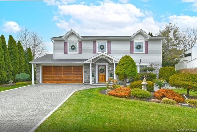 8 Brookstan Road Nesconset, NY 11767 - Photo 2 of 35 a front view of a house with a yard and garage