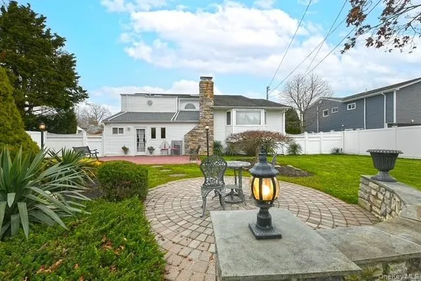 a view of a house with a yard and sitting area