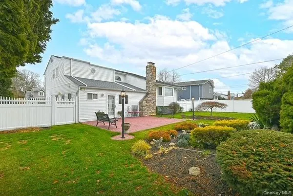 a view of backyard with seating area and trees