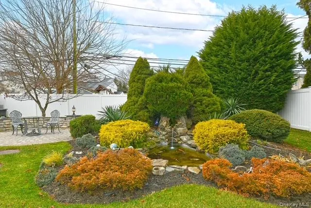 a view of backyard of house with green space