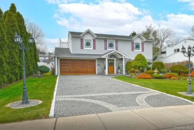 a front view of a house with a yard and a fountain