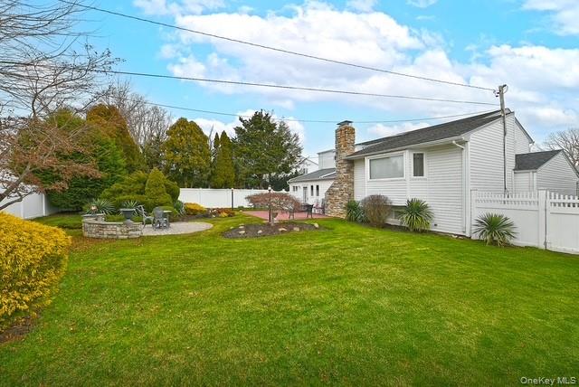 8 Brookstan Road Nesconset, NY 11767 - Photo 31 of 35 a view of backyard of house with green space