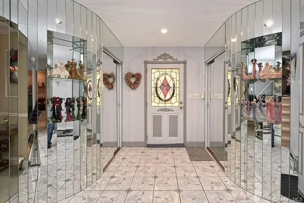 a view of a hallway with wooden floor and windows