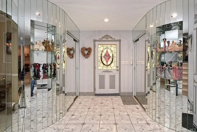 a view of a hallway with wooden floor and windows
