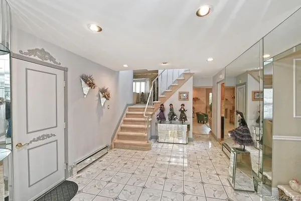 a dining room with wooden floor a chandelier a glass table and chairs