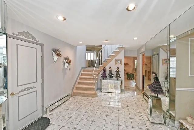 a dining room with wooden floor a chandelier a glass table and chairs
