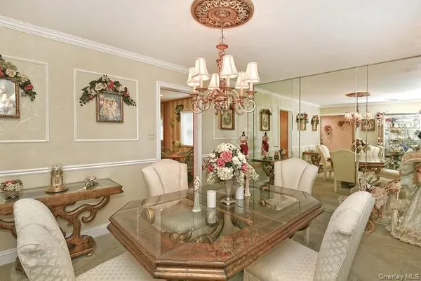a view of a dining room with furniture and chandelier