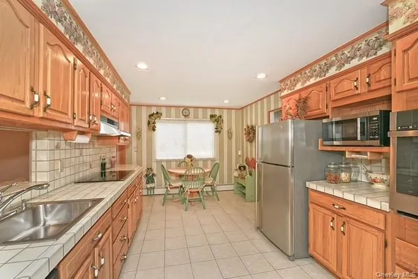 a dining room filled with furniture and a window