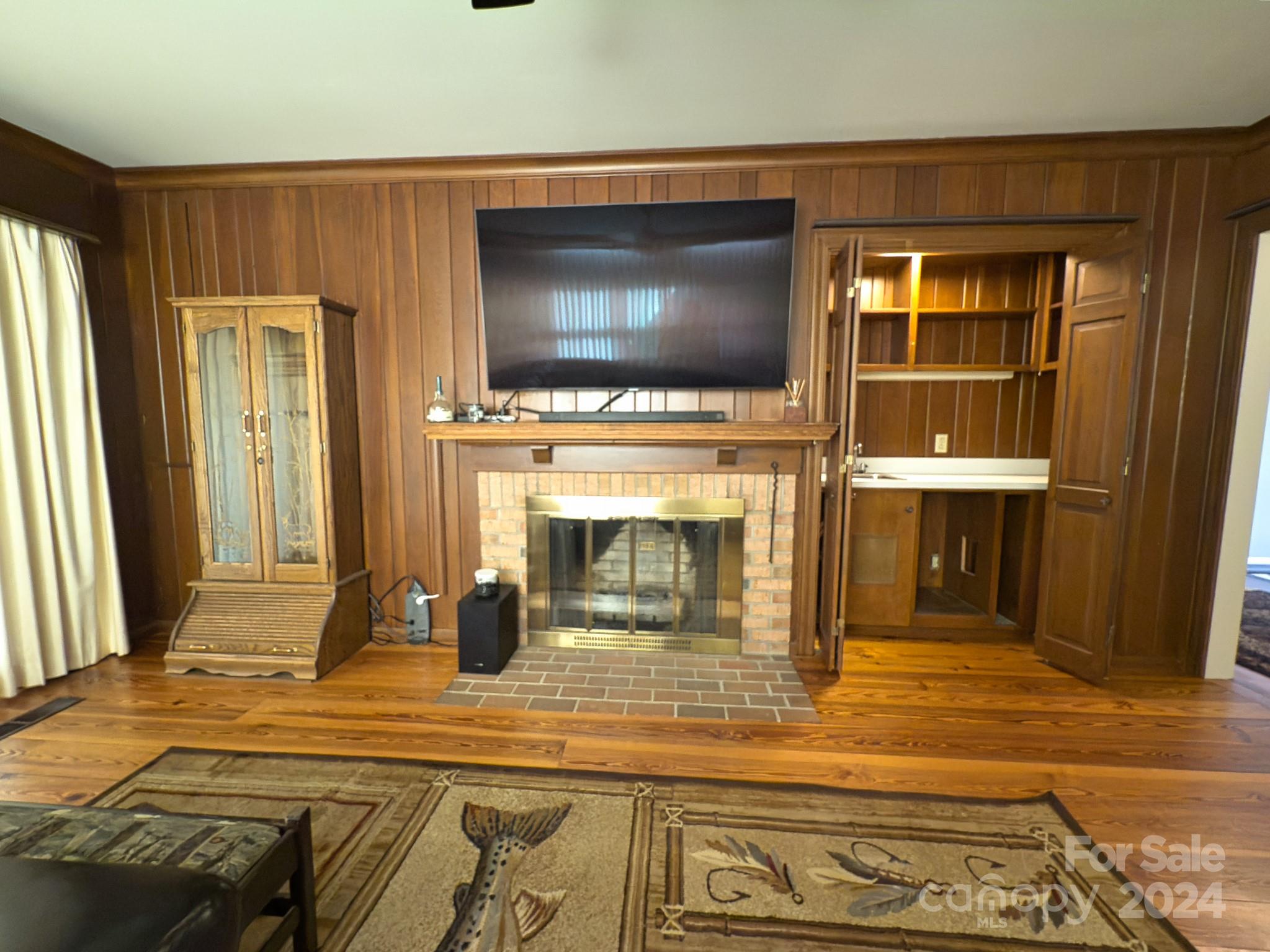 501 Hooper Creek Road Tryon, NC 28782 - Photo 17 of 34 a living room with fireplace and a flat screen tv