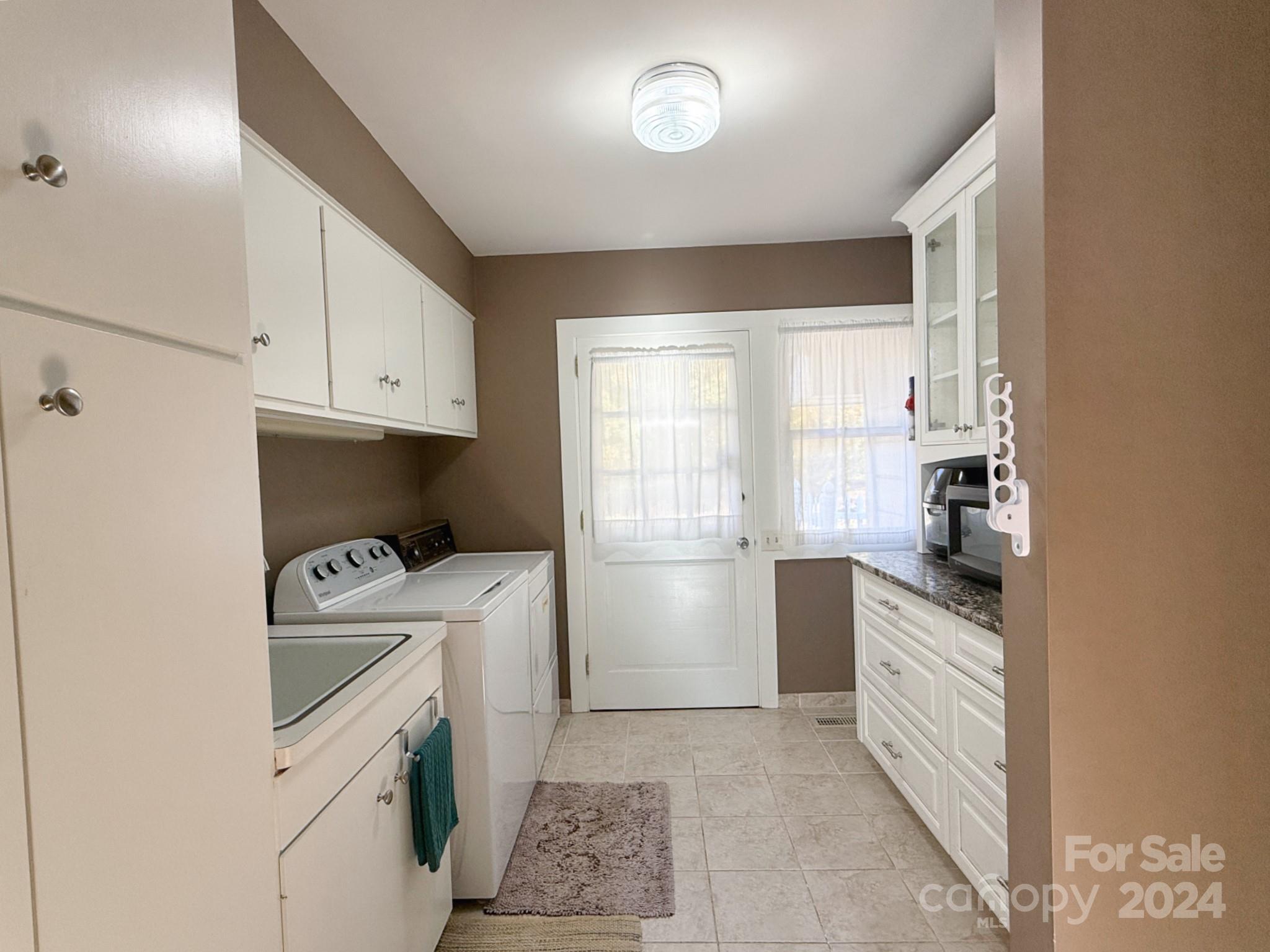 501 Hooper Creek Road Tryon, NC 28782 - Photo 21 of 34 a kitchen with a white cabinets and white appliances