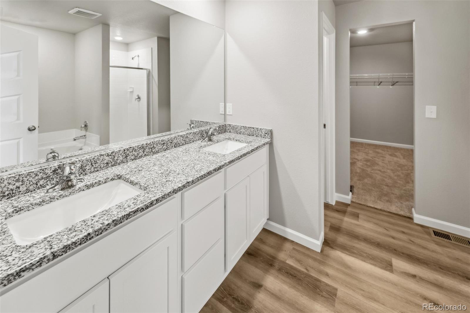 2220 Christina Street Fort Lupton, CO 80621 - Photo 13 of 42 a bathroom with a granite countertop sink and a mirror
