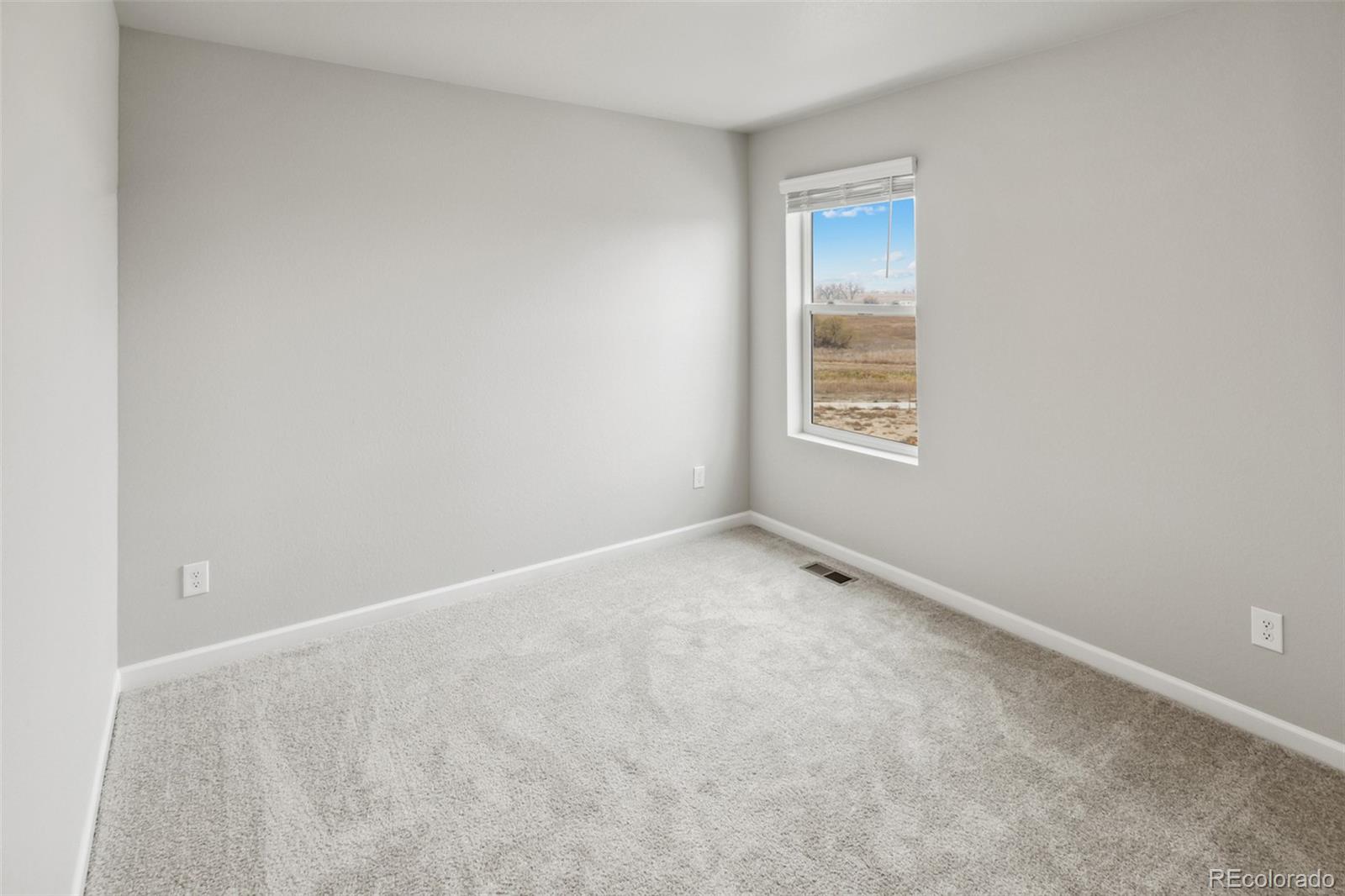 2220 Christina Street Fort Lupton, CO 80621 - Photo 18 of 42 a view of an empty room with a window