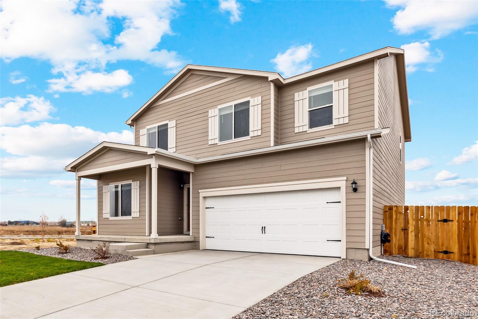 2220 Christina Street Fort Lupton, CO 80621 - Photo 2 of 42 a front view of a house with a yard