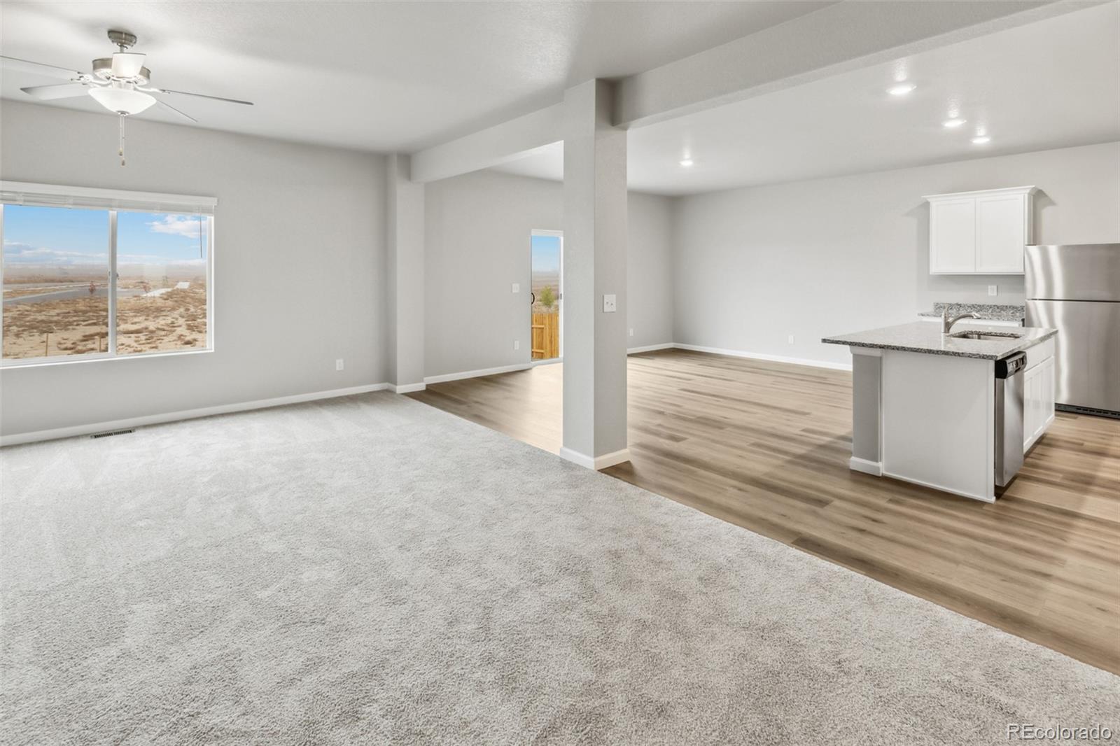 2220 Christina Street Fort Lupton, CO 80621 - Photo 7 of 42 a view of an empty room with kitchen appliances and a window