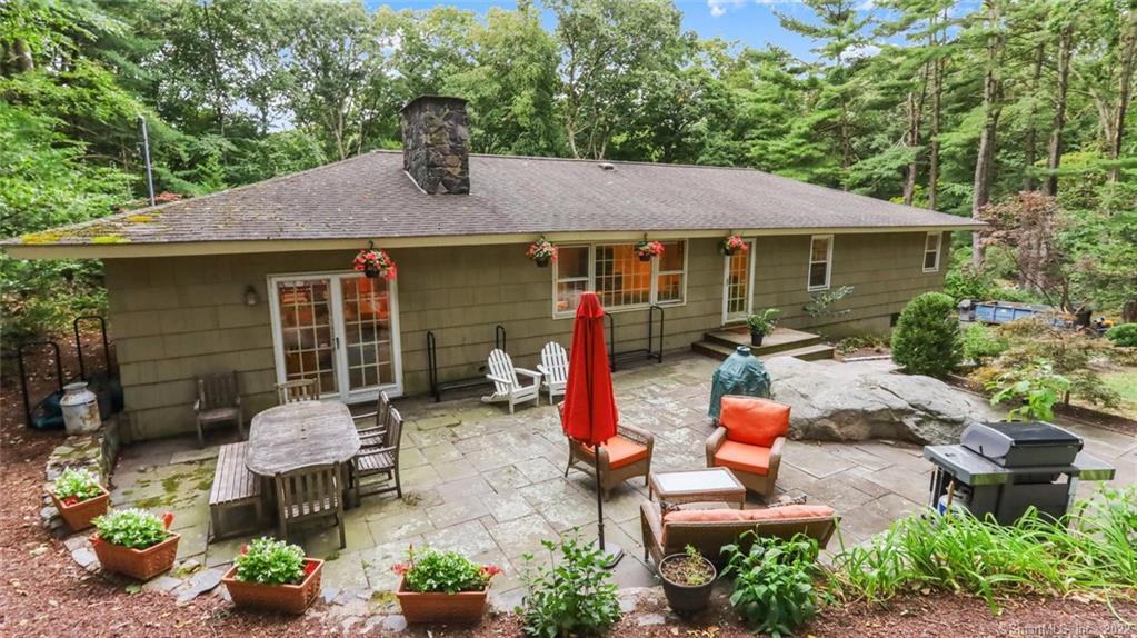 52 Range Road Wilton, CT 06897 - Photo 1 of 1 a backyard of a house with yard fire pit and outdoor seating