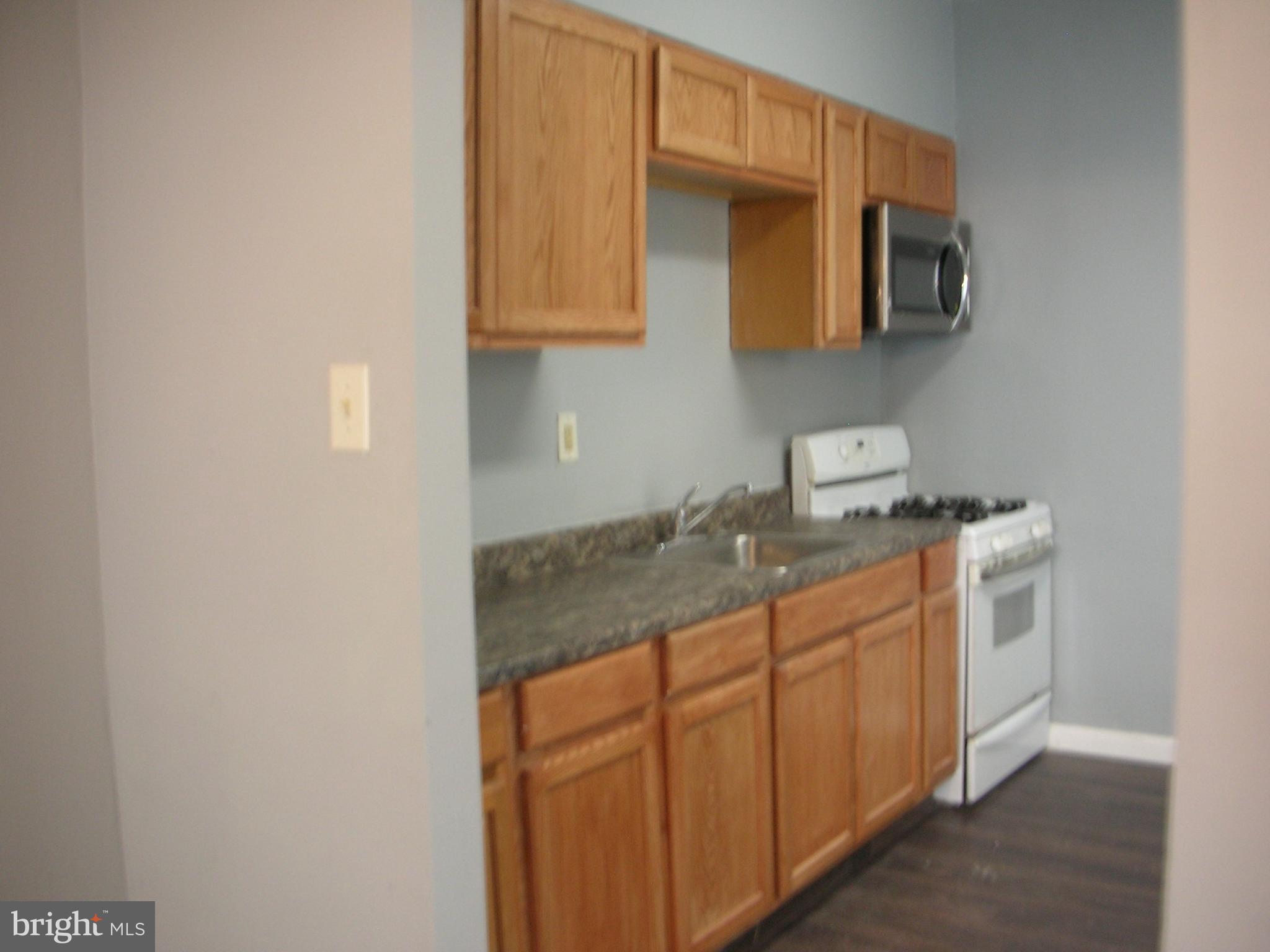 a kitchen with stainless steel appliances granite countertop a sink and a microwave oven