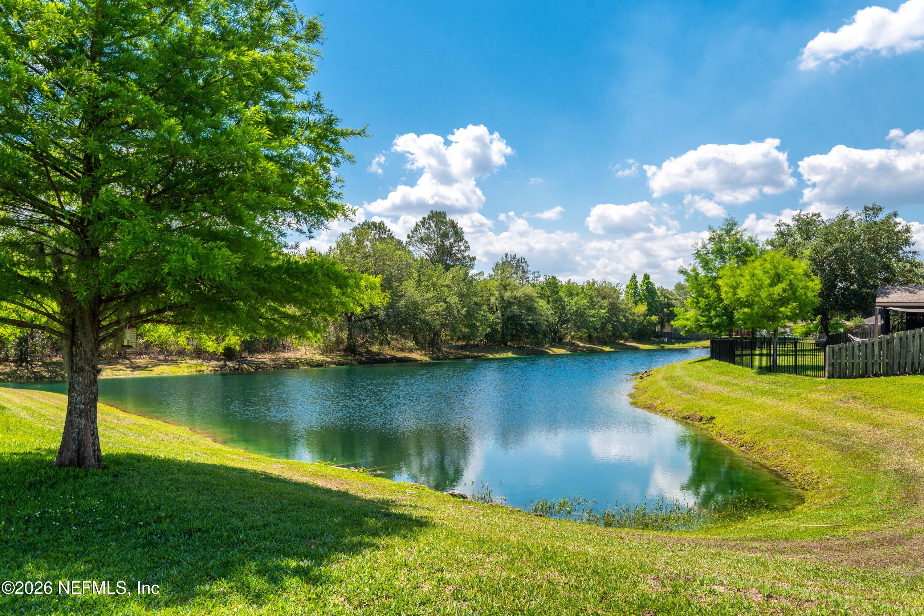 6178 Daylilly Road Macclenny, FL 32063 - Photo 29 of 29 a view of a lake with houses in the background