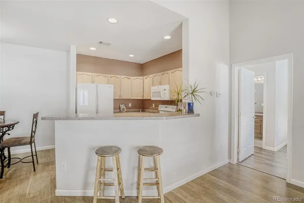 a kitchen with cabinets and chairs