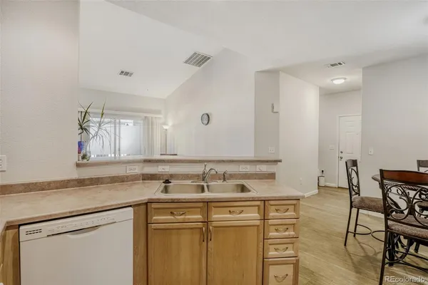a sink with white cabinets