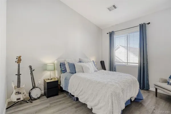 a bed room with a bed and a chair