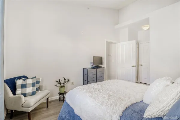 a bedroom with a bed and a chair