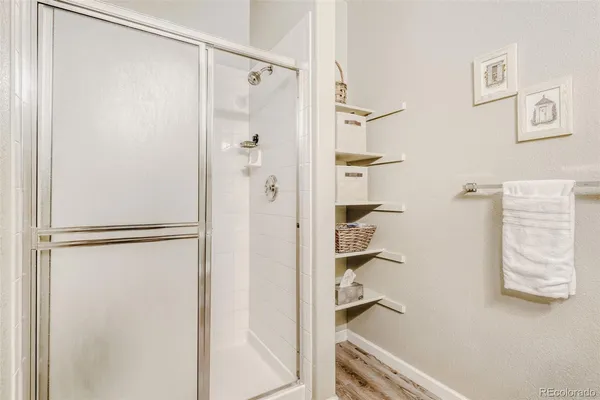 a bathroom with a shower and a glass door