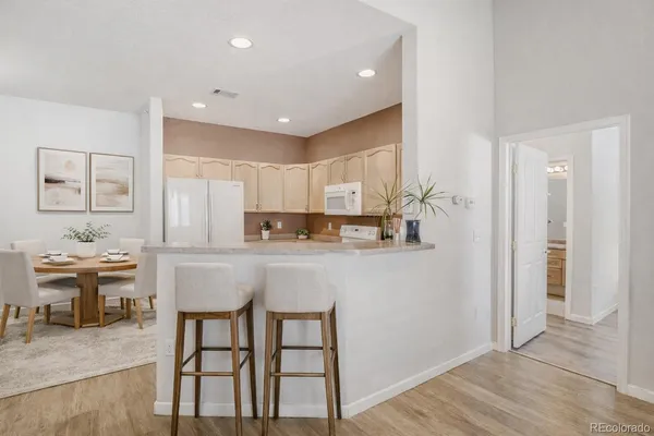a kitchen with cabinets and chairs