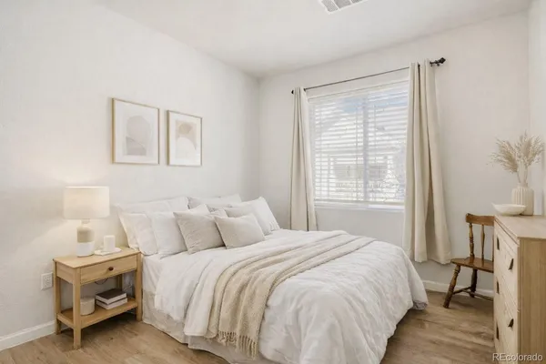 a bedroom with a bed and a table