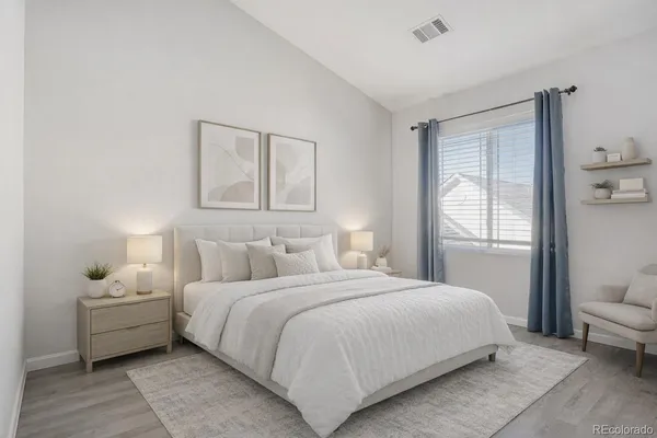 a bedroom with a bed and a couch